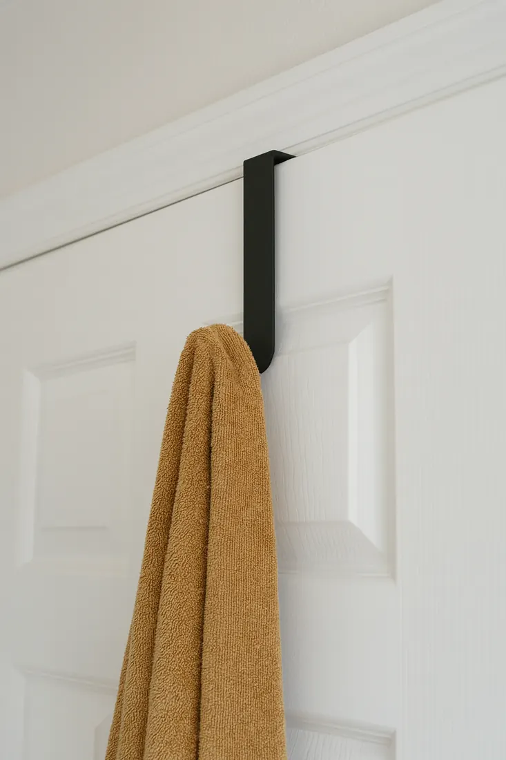 Over-the-door hook holding a towel